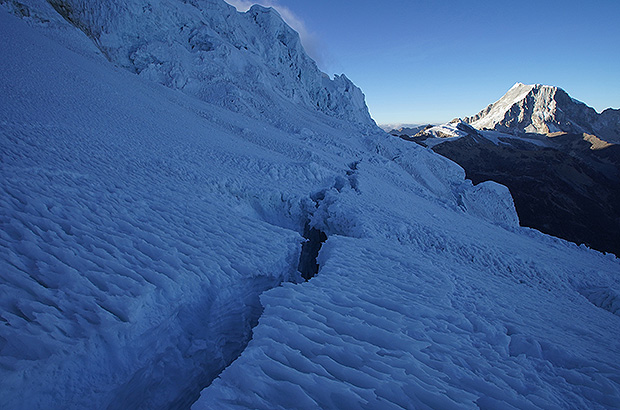 Huge crevasse at the base of the Nevado Tocllaraju summit dome - expanding, at least 100 m deep