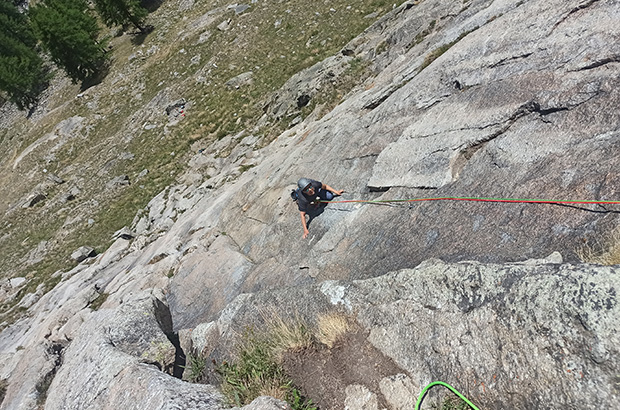 Climbing a rockclimbing alpine route of the category AD- in the El Paraiso National park in Northern Italy