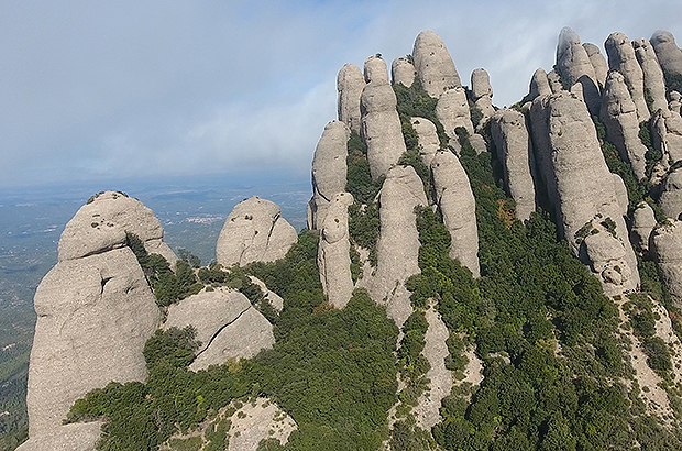 The rocky fingers of Montserrat comb through the clouds