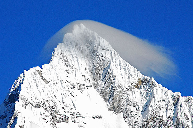 The summit of Alpamayo with a cloud decoration