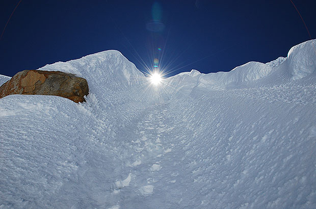 Climbing the Canaleta, a narrow ice chute leading to the summit ridge of the Alpamayo
