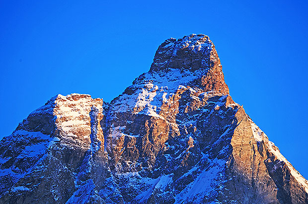 Southeast face of the Matterhorn. The popular traverse route is from left to right. Ascent by the Lion route and descent by the Hörnli.