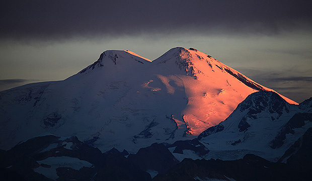 Mount Elbrus's eastern slope glows red at dawn