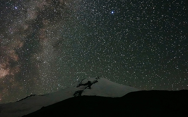 The eastern slope of Mount Elbrus under the starry dome of the night sky