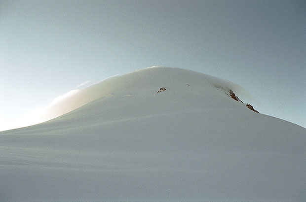 The summit dome of the top of Mount Kazbek in the lenticular cloud