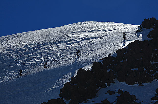 The descent of climbing team from the summit dome of Mount Kazbek