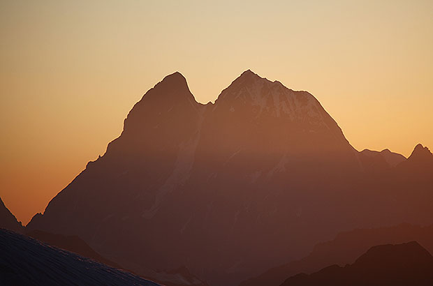 Silhouette of Mount Ushba at sunset - it is the symbol of Caucasian mountaineering