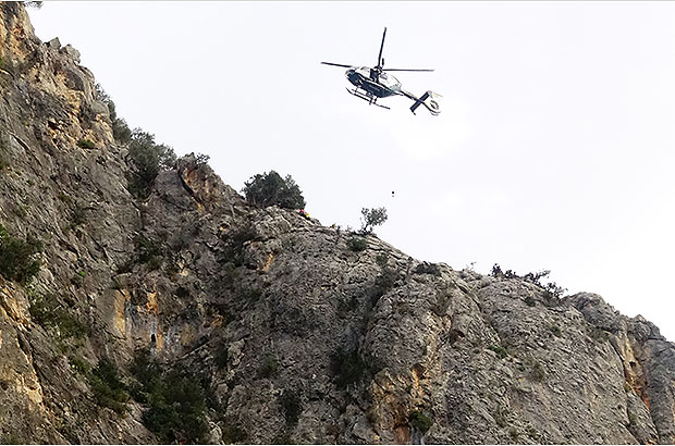 Rescuing the victim of the climbing accident from the steep rockclimbing route in Mallorca