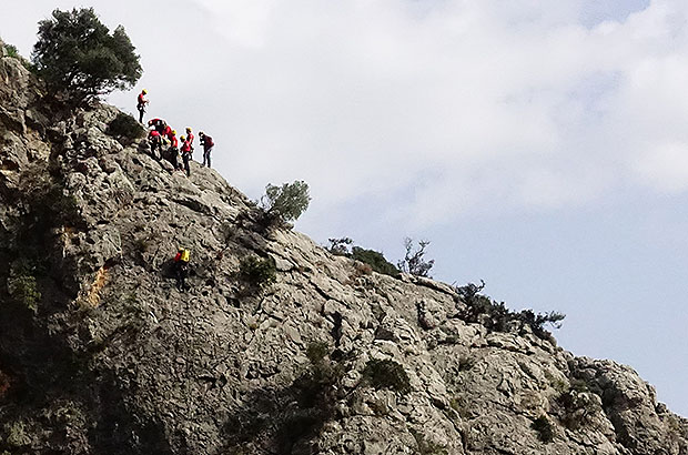 Rescue work with the taking the victim of climbing accident from the wall in the massif of Sa Gubia, Mallorca