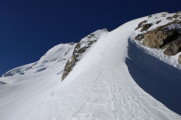 Climbing the steep snow slope in the base of the North Ridge of Dykh Tau