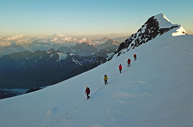 Climbing Mount Gestola in the Bezengi Wall - Mount Elbrus is barely visible on the dawn horizon