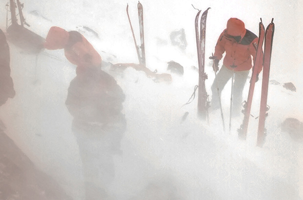 Setting up a tent in the snowstorm conditions during the winter climb of Mount Elbrus