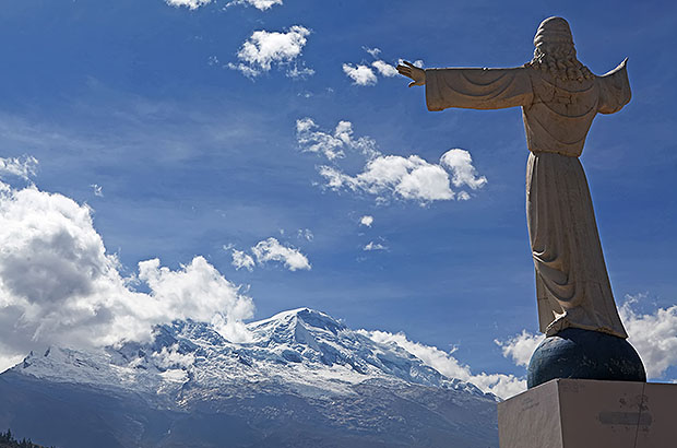 Statue of Christ in the center of the Yungay Memorial, facing the top of Nevado Huascaran