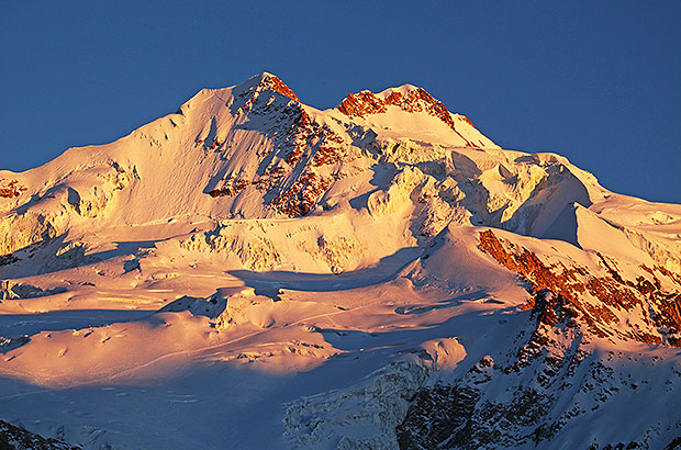 Sunrise view of Huayna Potosi peak from the very beginning of the route, from the hut at the altitude of 4700 m