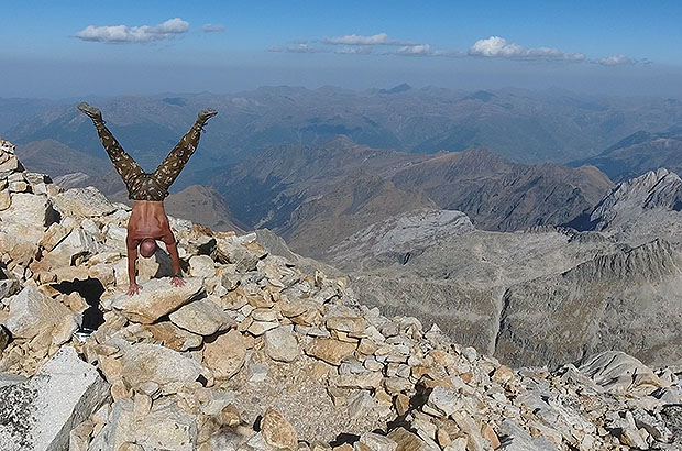 Handstand on summit of Peak Aneto - the highest mountain in the Pyrenees, Spain