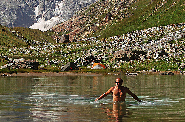 Caucasus. Relaxation in a mountain lake after a difficult climbing ascent