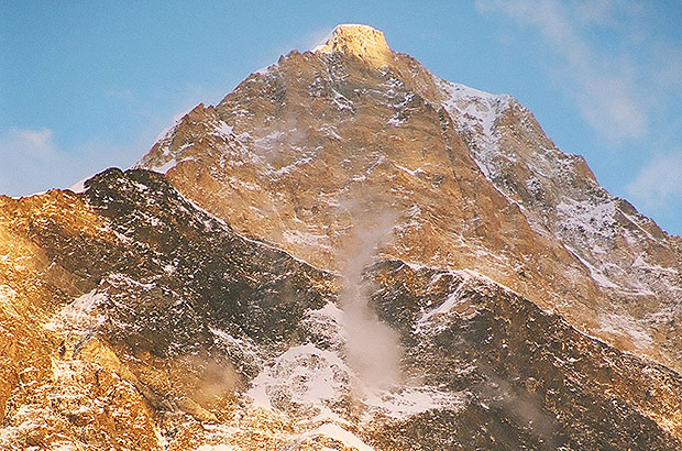 The summit tower of Khan Tengri at sunset is an enchanting sight of the 2-kilometer North Face