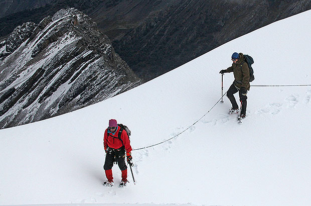 Climbers on the snowy ridge of the Diablo Mudo summit, Peru