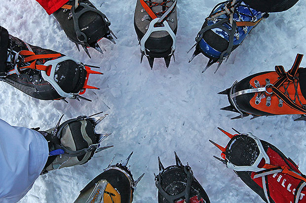 Checking crampons before iceclimbing training, Norway